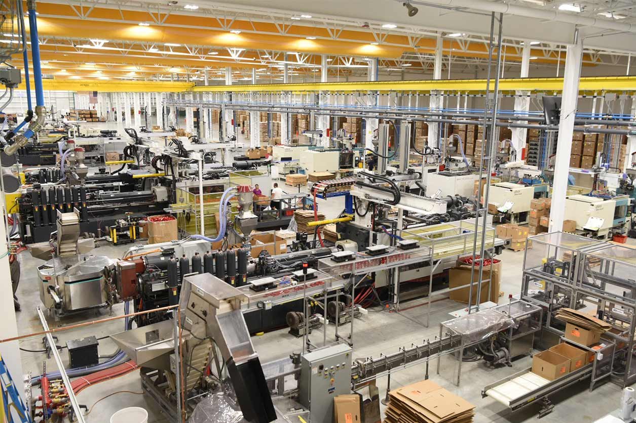 An advanced manufacturing floor with injection moulding machines and automated conveyor lines